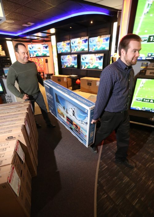 TREVOR HAGAN / WINNIPEG FREE PRESS
Alec Markusoff and Riley S. move inventory in preparation for Advance's boxing week sales known as the Krazy Karnival, Saturday, December 24, 2016.