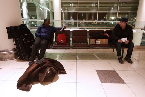 JOHN WOODS / WINNIPEG FREE PRESS
Stranded passenger Trevor Williamson (L), who was attending a wedding in Jamaica and is flying on to Kelowna, plans to spend his second night at the airport with his new airport buddy Frank Choe, whose flight to Calgary was also cancelled due to weather Sunday, December 25, 2016.