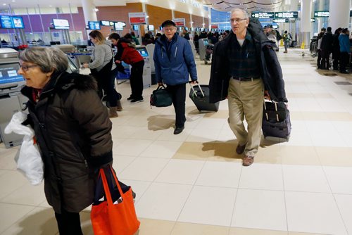 JOHN WOODS / WINNIPEG FREE PRESS
After a cancelled flight yesterday Dan Perlman who is heading to North Carolina makes his way to the departure lounge Monday, December 26, 2016. Except for some delays things were back on track at the Winnipeg airport after the Christmas day snowfall. 

