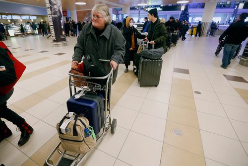 JOHN WOODS / WINNIPEG FREE PRESS
Marilyn Muller waits in line for over an hour for a taxi at the Winnipeg airport  Monday, December 26, 2016. Except for some flight delays things were back on track at the Winnipeg airport after the Christmas day snowfall.
