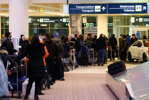 JOHN WOODS / WINNIPEG FREE PRESS
People wait in line for over an hour for a taxi at the Winnipeg airport  Monday, December 26, 2016. Except for some flight delays things were back on track at the Winnipeg airport after the Christmas day snowfall.
