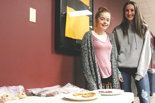 Canstar Community News Detinee Lefebevre (left) and Destinee Lefebevre (right) sold baked goods they made themselves to sell at South End Rugbys trivia night, which was a fundraiser to help get their team along with the boys team to get to Ireland for the summer. /Christina Hryniuk