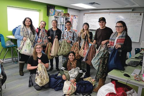 Canstar Community News Met School Social Justice League students with the care packaged they assembled for the homeless on Dec. 19, 2016.