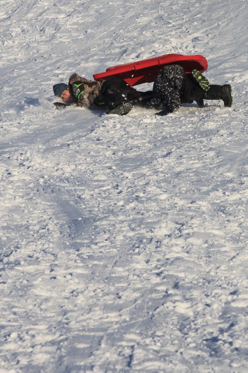 MIKE DEAL / WINNIPEG FREE PRESS
Aiden Stewart, 10, and Dylan Vencent, 8, wipeout while sledding down the big hill in Civic Park in East Kildonan Tuesday afternoon with temps hovering around -15C.
161227 - Tuesday, December 27, 2016.