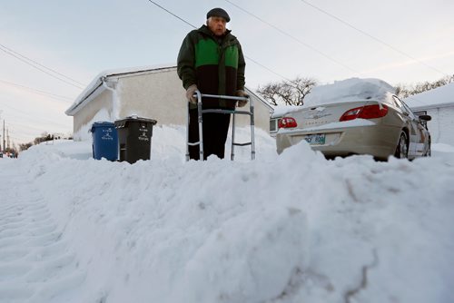 JOHN WOODS / WINNIPEG FREE PRESS
Barney Charach stands beside the windrow or snow bank made by the plows which makes it very difficult for them to get out of their garage Tuesday, December 27, 2016. Charach is disappointed with how the citys snow clearing affects seniors. 


