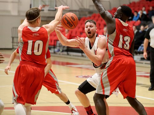 TREVOR HAGAN / WINNIPEG FREE PRESS
Winnipeg Wesmen's Ryan Oirbans, middle, fights for the ball between Algoma Thunderbirds' Sean Clendinning and Reng Gum during play at the Wesmen Classic, Wednesday, December 28, 2016.