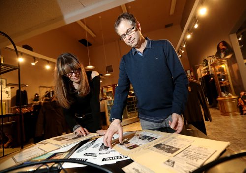 TREVOR HAGAN / WINNIPEG FREE PRESS
Marla and Avie Kaplan, owners of Village Streetwear, looking through a collection of old ads and newspaper clippings featuring the store dating back to the mid and late 80's. The pair are retiring after more than 30 years in business, Wednesday, December 28, 2016.