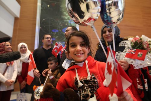 
RUTH BONNEVILLE / WINNIPEG FREE PRESS


Eight-year-old Syrian girl - Zainab Al Ali holds onto her balloons and Canadian flags tightly as she smiles widely while standing next to her family (the Al Ali family of five) consisting of her dad Khaled, mom Muntaha El Barakat (rear on right), her 8-year-old twin brother Zainab  and 20-month-old little sister Naya at Winnipeg at James Richardson International Airport Thursday afternoon.   See Carol Sanders story.  
 Dec 29, 2016