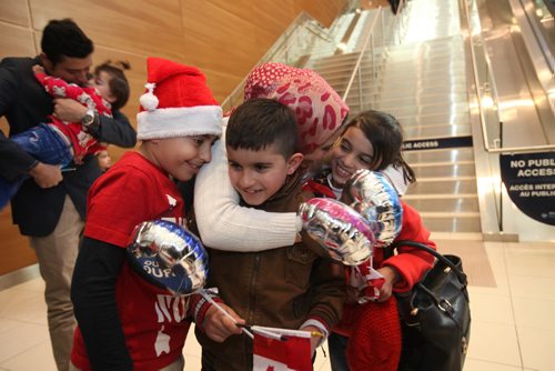 
RUTH BONNEVILLE / WINNIPEG FREE PRESS


Winnipegger Zainab Ali hugs her twin niece and nephew eight-year-old  Mohammad and Zainab Al Ali  after they arrive with their parents, Khaled, his wife Muntaha and their little sister Naya (20mnths) at James Richardson International Airport Thursday afternoon. Her son eight-year-old Mahammad Chaeban (santa hat) welcomes them with her while Tiba Al Abdellah, the children's uncle hugs his niece Naya Al Ali (20mnths) in the background.  
See Carol Sanders story.  
 Dec 29, 2016