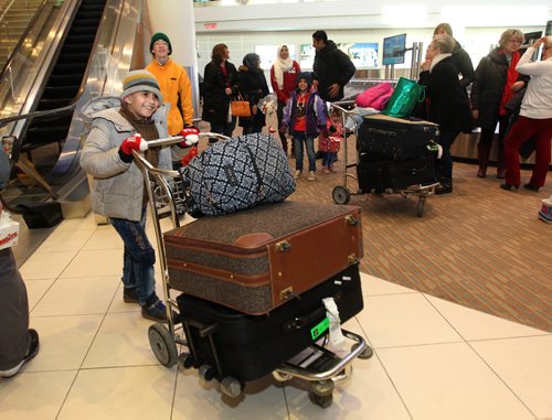 
RUTH BONNEVILLE / WINNIPEG FREE PRESS


Eight-year-old  Mohammad Al Ali is excited to push the suitcase cart to leave the airport after he arrived earlier with his family: dad - Khaled, mom - Muntaha, twin sister - Zainab and little sister - Naya (20mnths) at James Richardson International Airport Thursday afternoon. 
See Carol Sanders story.  
Dec 29, 2016