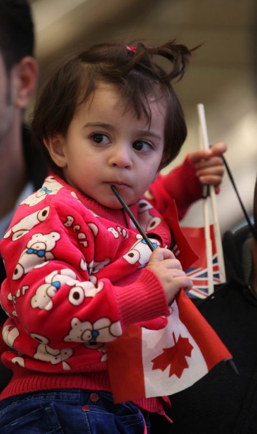 
RUTH BONNEVILLE / WINNIPEG FREE PRESS


Twenty-month-old Syrian girl Naya Al Ali Canadian flags tightly as she held by family members after arriving with her family into Winnipeg at James Richardson International Airport Thursday afternoon.   See Carol Sanders story.  
 Dec 29, 2016