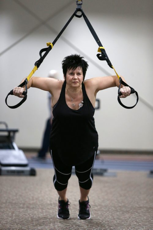 WAYNE GLOWACKI / WINNIPEG FREE PRESS 

Ent. Stacy Thiessen exercises with the TRX bands at the Reh-Fit Centre. Her husband died about two and a half years ago. She spent more than a year laying around on the couch, gaining weight. Basically she had given up. But last January--after a difficult holiday season--she started exercising. Since she has shed about 40 kilograms and just as important, she is in a much better head-space. (A personal trainer and dietitian also provide advice.) Joel Schlesinger story  Dec.30 2016