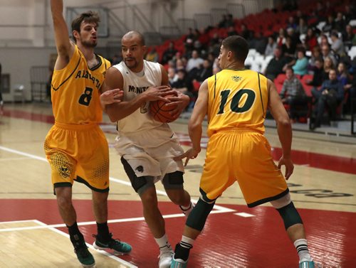 TREVOR HAGAN / WINNIPEG FREE PRESS
Manitoba Bisons' Keith Omoerah drives to the hoop between Alberta Golden Bears Lyndon Annetts and Brody Clarke in the final of the Wesmen Classic, Friday, December 30, 2016.