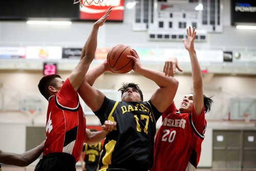 TREVOR HAGAN / WINNIPEG FREE PRESS
Dakota Lancers' Connor Kyliuk drives to the hoop between Sister Spartans Alec Canteras and Eliajah McKay during the high school final of the Wesmen Classic, Friday, December 30, 2016.
