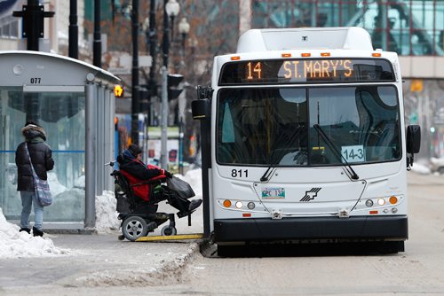 JOHN WOODS / WINNIPEG FREE PRESS
A wheelchair bound passenger gets on a city bus on Portage Avenue Sunday, January 1, 2017. Bus fares increase today.

