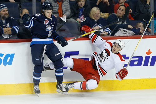 JOHN WOODS / WINNIPEG FREE PRESS
Manitoba Moose JC Lipon (34) checks Charlotte Checkers' Roland McKeown (3) during third period AHL action in Winnipeg on Sunday, January 1, 2017.