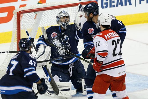 JOHN WOODS / WINNIPEG FREE PRESS
Manitoba Moose goaltender Ondrej Pavelec (31) saves the shot from Charlotte Checkers' Andrew Poturalski (22) as Moose Brian Strait (47) and Anthony Peluso (14) defend during third period AHL action in Winnipeg on Sunday, January 1, 2017.