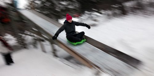 PHIL HOSSACK / WINNIPEG FREE PRESS -  Not to be outdone by her two children, Kerry Birch enjoys a ride down one of two toboggan slides at St Vital Park Monday afternoon. STAND UP. bJanuary 2,2017