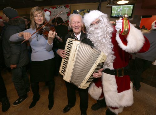 JASON HALSTEAD / WINNIPEG FREE PRESS

Daria Watkin (left) and Ozzie Aasland entertain the crowd with Santa Claus at the 11th annual X-Cues Café, West End BIZ, Sorrentos, Sons of Italy Christmas Eve Feast at X-Cues Café on Sargent Avenue in the West End on Dec. 24, 2016. (See Social Page)