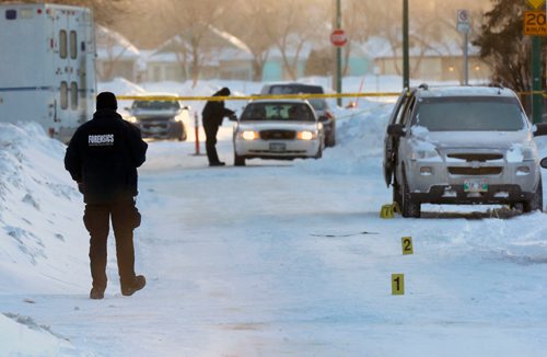 WAYNE GLOWACKI / WINNIPEG FREE PRESS 

Winnipeg Police Forensics officers investigate the scene by a vehicle on Thames Ave. near Watt St. Wednesday morning. Jan.4 2017