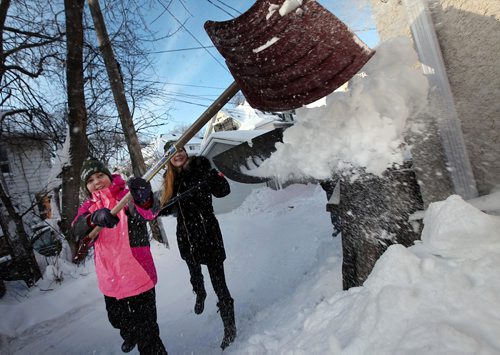 PHIL HOSSACK / WINNIPEG FREE PRESS -  Snow Angels Julia Sitarek (left in pink) and her sister Lauren  keep the snow flying Wednesday helping out seniors and shut ins by shovelling out their walkways. See release....January 4, 2017