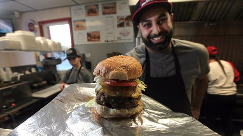 PHIL HOSSACK / WINNIPEG FREE PRESS -  Proprietor Andy Kostis shows off a "double deluxe" at "The Burger Place" on Portage ave. See Dave Sanderson's story. ....January 5 ,2017