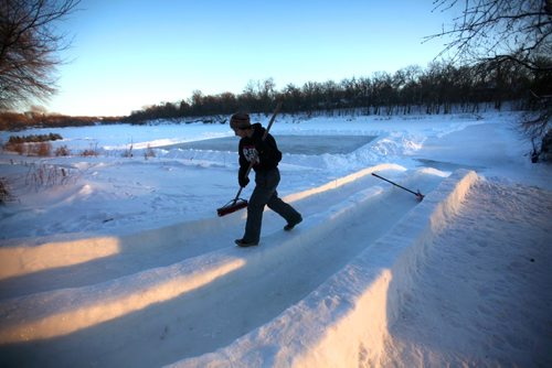 RUTH BONNEVILLE / WINNIPEG FREE PRESS

Devin Dorbolo polishes his families toboggan runs that make their way onto the Assiniboine River from their backyard on Assiniboine Ave. for his 18th birthday party later on in the evening.  The family has built the toboggan runs for many years  and share it with their neighbours who also make a ice rink when conditions are good.  Standup photo 
 Jan 05, 2017