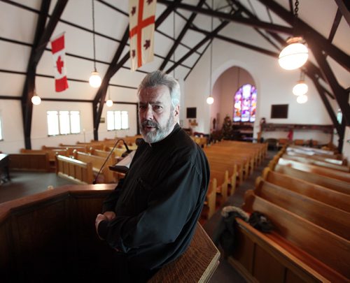 PHIL HOSSACK / WINNIPEG FREE PRESS - .Rev Donald McKenzie poses in his parish at St Philips Church in St Boniface Friday morning. See Intersection piece by Dave Sanderson. ...January 6, 2017