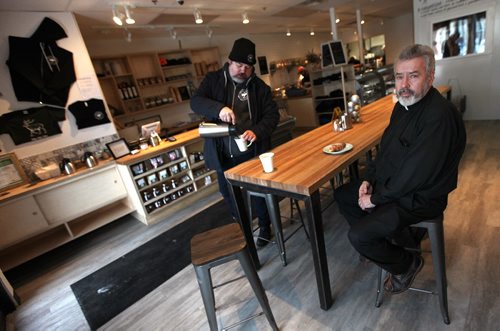 PHIL HOSSACK / WINNIPEG FREE PRESS - .Rev Donald McKenzie poses at a neighborhood bistro, Bouchee Boucher, near St Philips Church in St Boniface Friday morning. Owner Alex Svenne pours the coffee. See Intersection piece by Dave Sanderson. ...January 6, 2017