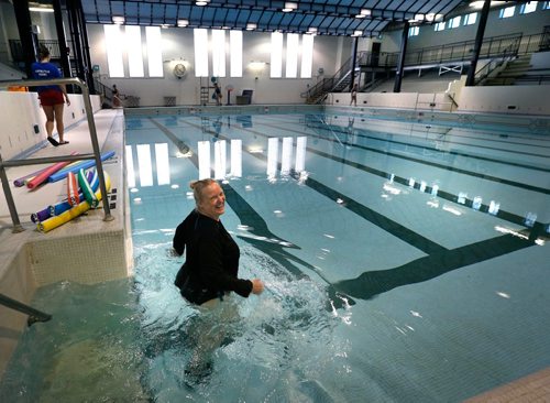 WAYNE GLOWACKI / WINNIPEG FREE PRESS 

After the speeches and the ribbon cutting ceremony for the official reopening of the Kinsmen Sherbrook Pool Monday morning, Aquasize instructor Pam Schlamp was the first to slip into the pool. 
Ashley Prest story.   Jan.9  2017