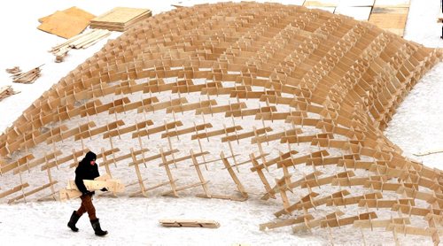 WAYNE GLOWACKI / WINNIPEG FREE PRESS 

    A member of the crew of builders working with the materials Monday that will eventually be the framework for architect Joe Kalturnyks design for this years RAW:almond pop up restaurant on the frozen Assiniboine River near The Forks. The sold out dining experience will run Jan.20 -Feb. 13. Limited seats will be available for for skate/walk ups wanting to attend the collaborative brunch. Jan.9  2017