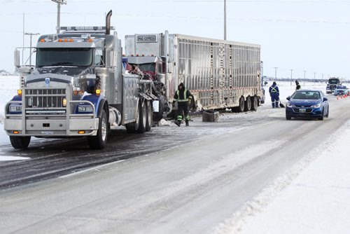 RUTH BONNEVILLE / WINNIPEG FREE PRESS

Crews with a towing company cleanup debris from a semi carrying hogs that  flipped on its side after being involved in an accident with an Emterra Garbage truck Tuesday.  One person was taken to hospital.

Standup photo 
 Jan 10, 2017