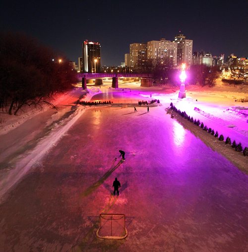 PHIL HOSSACK / WINNIPEG FREE PRESS -  RIVER TRAIL at NIGHT.....A pair of players line up shots on the Assinaboine River Tuesday night. Frigid temps were no barrier. Skaters cyclists and walkers started making their appearance Monday night when the Forks River trail opened officially for the season. ....January 10, 2017