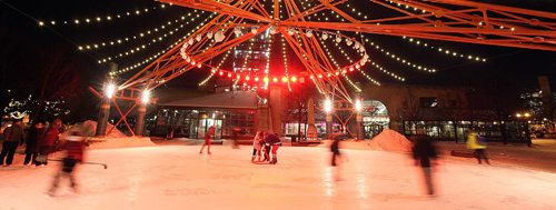 PHIL HOSSACK / WINNIPEG FREE PRESS -  RIVER TRAIL at NIGHT.....Skaters blur around a family at center ice underneath the dome of lights at the Forks Market. Frigid temps were no barrier. Skaters cyclists and walkers started making their appearance Monday night when the Forks River trail opened officially for the season. ....January 10, 2017