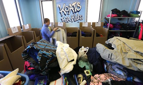 JASON HALSTEAD / WINNIPEG FREE PRESS

A volunteer works amid unsorted winter clothing donations at Koats for Kids headquarters on Portage Avenue in Assiniboia on Jan. 10, 2017. (See Social Page)