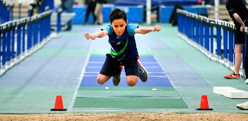 PHIL HOSSACK / WINNIPEG FREE PRESS -  Optomist Club track team's Connor Hutchison-Campbell  (11) leans into his standing long jump Wednesay at the U of M's James Daley Fieldhouse.  ....January 11, 2017