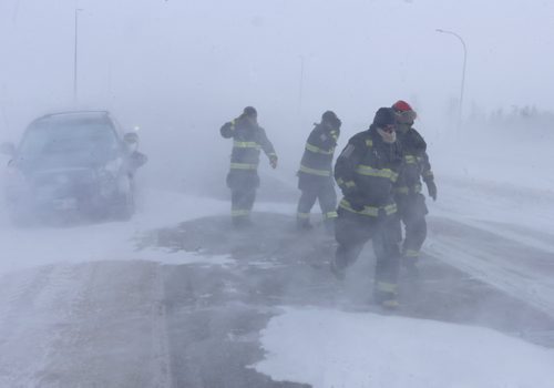 WAYNE GLOWACKI / WINNIPEG FREE PRESS
Fire Fighters at the scene of a  12-car pileup McPhillips and the
Perimeter in white out conditions.
Weather standup 
Jan 12 / 2017