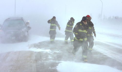 WAYNE GLOWACKI / WINNIPEG FREE PRESS 

Fire Fighters at the scene of aprox. 12-car pileup McPhillips St. and the Perimeter Hwy. Thursday morning in near white out conditions.   Jan.12  2017