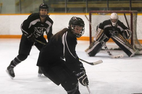 PHIL HOSSACK / WINNIPEG FREE PRESS -  U of M Bison Erica Rieder (front) works the puck towards team mate Alanna Sharman (left) at the team workout Thursday. Sorry no name for the netminder. See story. ....January 12, 2017