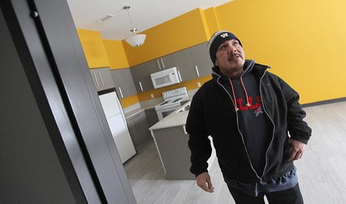 PHIL HOSSACK / WINNIPEG FREE PRESS -  Harry Williams sizes up a door he learned to install in a suite at the Austin Family Commons. Harry helped work on the construction of the family housing unit. See Carol Sander's story. . ....January 13, 2017