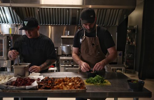 MIKE DEAL / WINNIPEG FREE PRESS

Chef Ben Kramer (right) prepares a dish during the Winnipeg Free Press Sunday Brunch Collective at the Kitchen Sync. 
This course is his take on Fish and Chips; a celery root purée, halibut, garlic cream, vegetable chips, and pea leaves. 

170115
Sunday, January 15, 2017