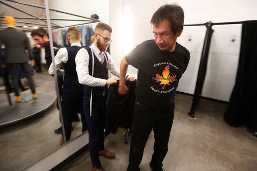 JOHN WOODS / WINNIPEG FREE PRESS
Andy Meekis, Main Street Project client, is fitted for a new suit by Brett Kuchciak, regional sales manager at EPH Apparel, Monday, January 16, 2017. Clients and former clients are being fitted to walk the runway in The Runway To Change, a Main Street Project fundraising fashion show.