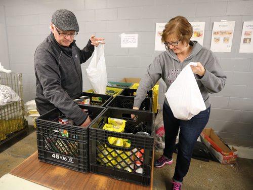 JASON HALSTEAD / WINNIPEG FREE PRESS

L-R: First-time volunteers Mario and Monelle Collette work in the warehouse at Winnipeg Harvest on Jan. 11, 2017. (See Social Page)