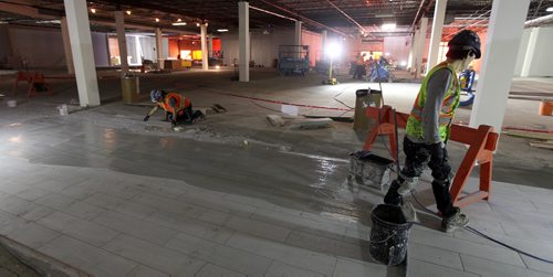 PHIL HOSSACK / WINNIPEG FREE PRESS - Tilers work on the new public walkways, preparing for new tenants at Kildonan Place Mall Thursday. See Murray McNeil story. ....January 19, 2017