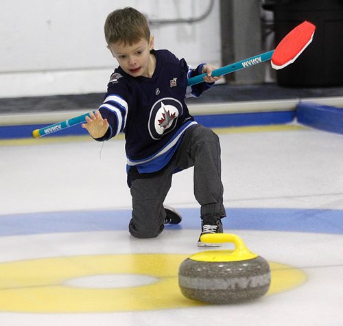 PHIL HOSSACK / WINNIPEG FREE PRESS - Vic Peters' 7 yr old grandson Jacob Leafloor throws out the opening rock at  the Fort Garry Curling Club Thursday. See Jason Bell's story.  ....January 19, 2017
