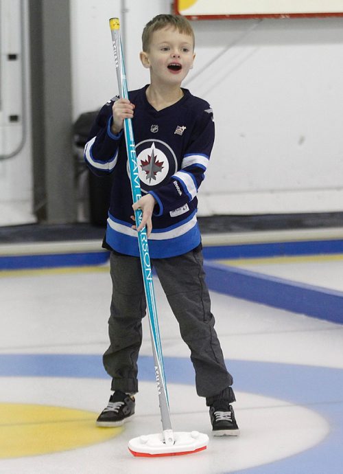 PHIL HOSSACK / WINNIPEG FREE PRESS - Vic Peters' 7 yr old grandson Jacob Leafloor throws out the opening rock then roars at it heads to the far "button" at  the Fort Garry Curling Club Thursday. See Jason Bell's story.  ....January 19, 2017