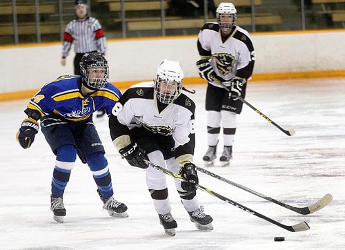 PHIL HOSSACK / WINNIPEG FREE PRESS - Manitoba Bison # 8 Carity Price stick handles past Lethbridge Pronghorn #14 Delaney Duchek Friday evening at Wayne Flemming Arena in the first game of a weekend matchup. Defencewoman, #13 Jayden Skoleski watches. AGATE STAND-UP.  January 20, 2017