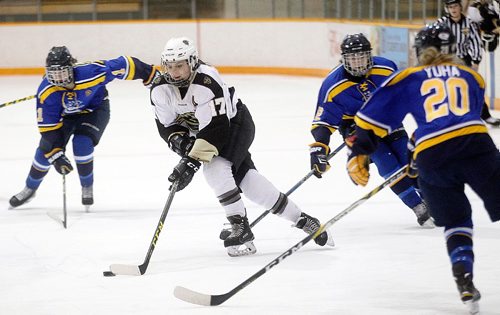 PHIL HOSSACK / WINNIPEG FREE PRESS - Manitoba Bison # 17 Erica Rieder makes her way through  Lethbridge Pronghorn traffic Friday evening at Wayne Flemming Arena in the first game of a weekend matchup. AGATE STAND-UP.  January 20, 2017