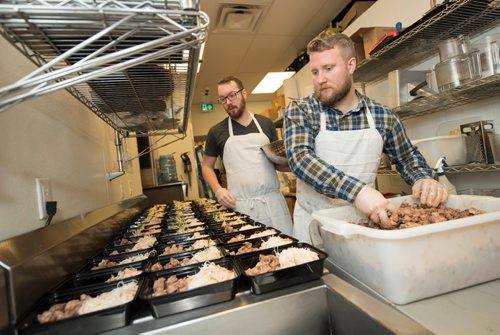 DAVID LIPNOWSKI / WINNIPEG FREE PRESS 

(Left to right) Prairie Box co-owners Lewis Glassey and Brandon Schofield prepare this week's meals in the kitchen of Fionn MacCool's Sunday January 22, 2017. Prairie Box is Winnipeg's first subscription, restaurant-style meal delivery service.