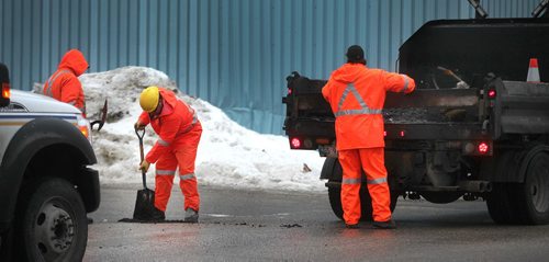 PHIL HOSSACK / WINNIPEG FREE PRESS - A city crew patches potholes along Wall street Monday. . .....See Aldo Santin story.  ....January 23, 2017